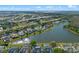 Aerial view of home on lake showcasing landscaping, and neighborhood at 4229 Settlers Ct, St Cloud, FL 34772