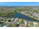 Beautiful aerial view of a lakeside home with well-manicured lawn and community at 4229 Settlers Ct, St Cloud, FL 34772