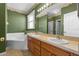 Well-lit bathroom features a double sink vanity, large mirror, and shower-tub combo at 4229 Settlers Ct, St Cloud, FL 34772
