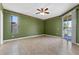 Bright bedroom with neutral tile flooring, large window, and sliding glass door access to outdoor patio at 4229 Settlers Ct, St Cloud, FL 34772