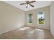 Bright bedroom featuring tile floors, ceiling fan, and natural light from two large windows at 4229 Settlers Ct, St Cloud, FL 34772