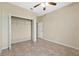 Comfortable bedroom with tile flooring, ceiling fan, and spacious closet at 4229 Settlers Ct, St Cloud, FL 34772