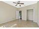 Bedroom with tile floors, and open closet, showing neutral colors and lots of light at 4229 Settlers Ct, St Cloud, FL 34772