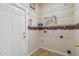 Functional laundry room with ample shelving and neutral colors at 4229 Settlers Ct, St Cloud, FL 34772
