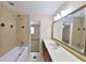 Tiled bathroom with a shower-tub combo, vanity, and a large mirror at 426 S Lakemont Ave, Winter Park, FL 32792