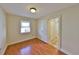 Bedroom with hardwood floors, natural light, and ensuite laundry room at 426 S Lakemont Ave, Winter Park, FL 32792