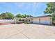 Charming single-story home with a spacious three car garage, lush landscaping, and a freshly painted exterior at 426 S Lakemont Ave, Winter Park, FL 32792