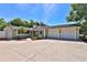 Charming single-story home boasts a spacious driveway, attached garage, and vibrant landscaping at 426 S Lakemont Ave, Winter Park, FL 32792
