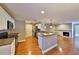 Open concept kitchen has a breakfast bar, stainless steel appliances, and view of fireplace at 426 S Lakemont Ave, Winter Park, FL 32792