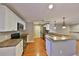 Bright kitchen features stainless steel appliances, white cabinetry and a breakfast bar, great for entertaining at 426 S Lakemont Ave, Winter Park, FL 32792