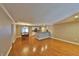 Open concept living room with hardwood floors, dining area, and a view of kitchen bar at 426 S Lakemont Ave, Winter Park, FL 32792