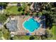 Aerial view of a community pool and playground, surrounded by tropical landscaping at 4918 Oakway Dr, St Cloud, FL 34771