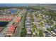 Aerial view of a neighborhood featuring a lake and well-maintained properties with a mix of roof colors at 4918 Oakway Dr, St Cloud, FL 34771