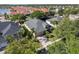 An aerial view shows the home's mature landscaping, paved driveway, and proximity to a nearby pond at 4918 Oakway Dr, St Cloud, FL 34771