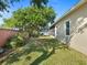 A well-maintained backyard with lush lawn, mature trees, and a private brick-walled boundary at 4918 Oakway Dr, St Cloud, FL 34771