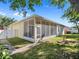 Rear exterior shot of a home featuring a screened in porch, an easy access door and a well manicured backyard at 4918 Oakway Dr, St Cloud, FL 34771