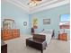 A large, light blue bedroom features a tray ceiling with a ceiling fan, two windows, and a large dresser at 4918 Oakway Dr, St Cloud, FL 34771