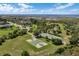 Aerial view of community amenities including basketball and tennis courts with homes and a lake in the background at 4918 Oakway Dr, St Cloud, FL 34771