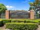 Community sign on a brick and wrought iron monument says, 