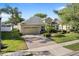 Inviting home featuring a well-kept lawn and brick driveway leading to a two-car garage at 4918 Oakway Dr, St Cloud, FL 34771