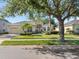 Well-maintained home with lush lawn, mature trees, and inviting curb appeal at 4918 Oakway Dr, St Cloud, FL 34771
