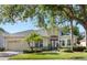 Charming single-story home featuring a well-manicured lawn, mature trees, and a two-car garage at 4918 Oakway Dr, St Cloud, FL 34771