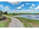 Scenic lake view along a walking path with lush greenery in a beautiful community at 4918 Oakway Dr, St Cloud, FL 34771