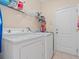 Functional laundry room with a washer, dryer, and shelving for storage at 4918 Oakway Dr, St Cloud, FL 34771