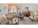 Cozy living room features comfortable seating, a piano, and a large window with decorative curtains at 4918 Oakway Dr, St Cloud, FL 34771