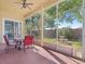 Screened in patio with table and chairs overlooks a well-maintained backyard and mature landscaping at 4918 Oakway Dr, St Cloud, FL 34771