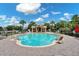 Beautiful community pool with lounge chairs and a cabana under a bright blue sky at 4918 Oakway Dr, St Cloud, FL 34771