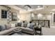 Comfortable bonus room featuring a large gray sectional, ceiling fan, neutral walls, and railing overlooking the lower level at 5248 Stone Ridge Pl, St Cloud, FL 34771