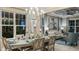 Bright and airy dining room with large windows, elegant decor, and an open layout to the living area at 5248 Stone Ridge Pl, St Cloud, FL 34771