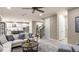 Open floor plan showcasing the kitchen and living room with hardwood floors and comfortable seating for entertaining at 5248 Stone Ridge Pl, St Cloud, FL 34771
