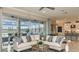 Bright living room with glass doors leading to a patio, comfortable sectional, and kitchen view at 5248 Stone Ridge Pl, St Cloud, FL 34771