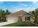 Charming one-story home featuring a neutral color scheme, a two-car garage, and tidy landscaping at 576 Mahogany Way, Dundee, FL 33838