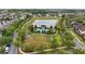Aerial view of neighborhood featuring community pool, playground, pond, sidewalks, and green spaces at 5892 Soter Ln, Windermere, FL 34786
