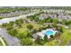 Aerial view of neighborhood featuring community pool, playground, pond, sidewalks, and green spaces at 5892 Soter Ln, Windermere, FL 34786