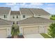 An aerial view of a well-maintained townhome community, featuring garages and manicured landscaping at 5892 Soter Ln, Windermere, FL 34786
