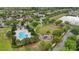 Aerial view of neighborhood featuring community pool, playground, pond, sidewalks, and green spaces at 5892 Soter Ln, Windermere, FL 34786