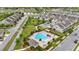 Aerial view of neighborhood featuring community pool, sidewalks, green spaces, and various home elevations at 5892 Soter Ln, Windermere, FL 34786