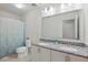 Bathroom featuring double vanity, granite countertop, and shower with tub at 5892 Soter Ln, Windermere, FL 34786