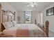 Bright bedroom featuring a wooden bed frame, plush carpet, and a sunlit window at 5892 Soter Ln, Windermere, FL 34786