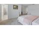 Bright bedroom featuring a wooden bed frame, plush carpet, and an en-suite bathroom at 5892 Soter Ln, Windermere, FL 34786