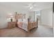 Bright bedroom featuring a wooden bed frame, plush carpet, and a ceiling fan at 5892 Soter Ln, Windermere, FL 34786