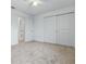 Bedroom featuring neutral carpet, closet, and door to bathroom at 5892 Soter Ln, Windermere, FL 34786