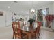 Bright dining room featuring an elegant light fixture, and a view of the open kitchen concept at 5892 Soter Ln, Windermere, FL 34786