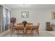 Bright dining room featuring a wooden table with six chairs and a contemporary light fixture at 5892 Soter Ln, Windermere, FL 34786