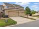 Well maintained townhome featuring a two-car garage, manicured landscaping, and a traditional exterior elevation at 5892 Soter Ln, Windermere, FL 34786
