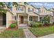Charming tan two-story townhome with landscaped yard and brick walkway at 5892 Soter Ln, Windermere, FL 34786